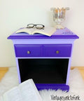 Dixie Belle Paint Amethyst Chalk Mineral Paint is the perfect paint for any DIY project! End table painted with our deep purple Amethyst Chalk Mineral Paint staged with a book, reading glasses and a book.