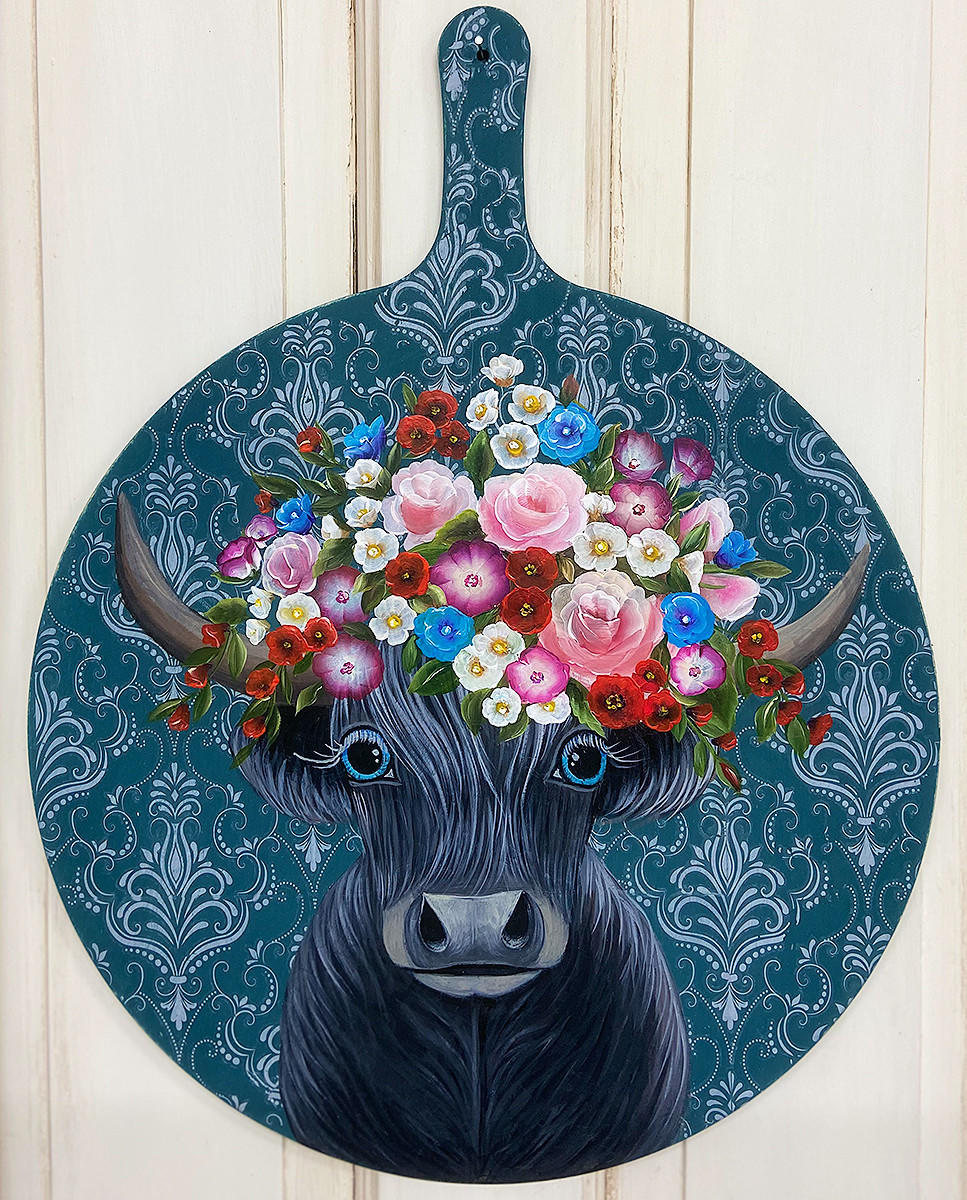 Dixie Belle Paint Antebellum Blue Chalk Mineral Paint is the perfect paint for any DIY project! Cutting board with hand painted cow, pink, purple and white flowers against Antebellum Blue Chalk Mineral Paint background and white damask stencil.