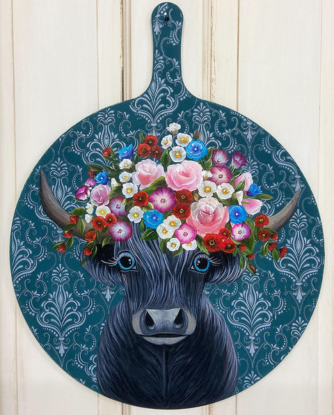 Dixie Belle Paint Antebellum Blue Chalk Mineral Paint is the perfect paint for any DIY project! Cutting board with hand painted cow, pink, purple and white flowers against Antebellum Blue Chalk Mineral Paint background and white damask stencil.