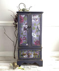 Dixie Belle Paint Aubergine Chalk Mineral Paint is the perfect paint for any DIY project! This tall wardrobe is painted with Aubergine Chalk Mineral Paint. The bottom of the cabinet is striped with a light green  adn the entire cabinet is accented with with our Buds and Branches transfer.