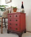 Dixie Belle Paint Barn Red Chalk Mineral Paint is the perfect paint for any DIY project! Red chalk painted side table that was blended with darker chalk paint to create an ombre appearance. Staged with a wine bottle.