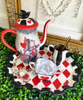 Dixie Belle Paint Barn Red Chalk Mineral Paint is the perfect paint for any DIY project! Chalk painted Metal tea pitcher and chalk painted metal tray with chalk painted metal sugar and creamer. Painted with a whimsical flare, black chalk paint with red and white chalk painted squares. Also, Alice Rub on Furniture Transfers was applied to the chalk painted tea pitcher.