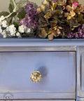 Dixie Belle Paint Blueberry Chalk Mineral Paint is the perfect paint for any DIY project!
Close up of dresser painted in Blueberry Chalk Mineral Paint with gold hardware and white distress detail around drawer.
