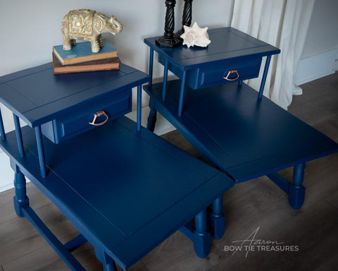 Dixie Belle Paint Bunker Hill Blue Chalk Mineral Paint is the perfect paint for any DIY project!
Vintage end table set painted in Bunker Hill Blue Chalk Mineral Paint. Staged with books and a golden elephant on top of one table the other had a seashell.