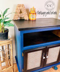 Dixie Belle Paint Bunker Hill Blue Chalk Mineral Paint is the perfect paint for any DIY project!
Cabinet painted in Bunker Hill Blue Chalk Mineral Paint with No pain Gel stain in black for the top, cubby hole and along the cane doors.