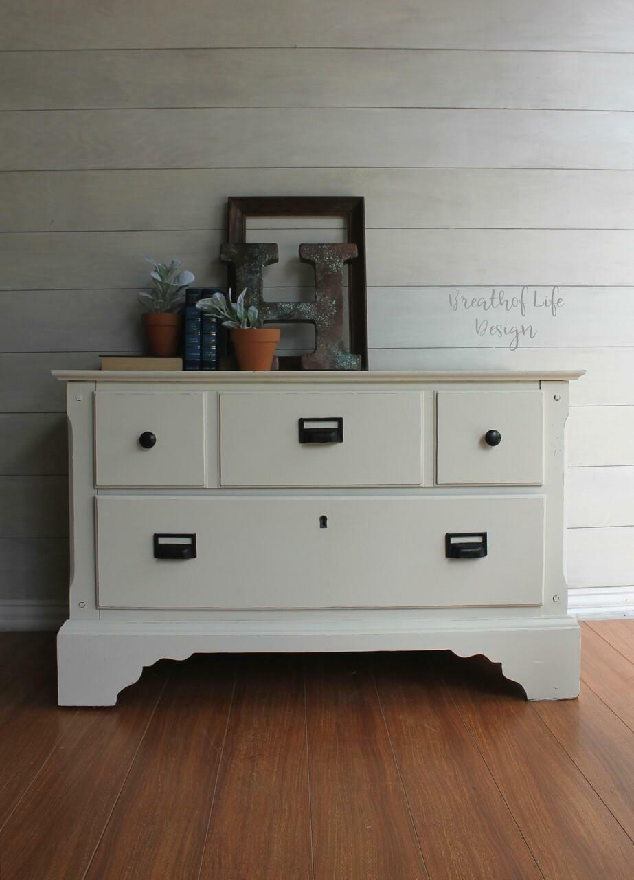 Dixie Belle Paint Buttercream Chalk Mineral Paint is the perfect paint for any DIY project!
Dresser painted in Buttercream Chalk Mineral Paint with black hardware. Staged with books,terracotta pots and a rusty H on top of on the dresser.