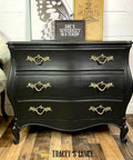 Dixie Belle Paint Caviar Chalk Mineral Paint is the perfect paint for any DIY project!
Dresser painted in Caviar Chalk Mineral Paint with gold hardware staged with a framed sign that reads " SHE'S WHISKEY IN A TEACUP" on the top.