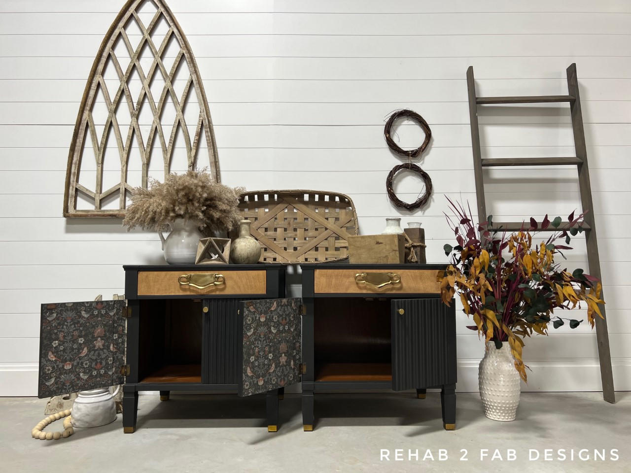 Dixie Belle Paint Caviar Chalk Mineral Paint is the perfect paint for any DIY project!
Two end tables painted in Caviar Chalk Mineral Paint with a wood stained drawer and gold hardware. Staged against a white wall and rustic decor on top of the tables.