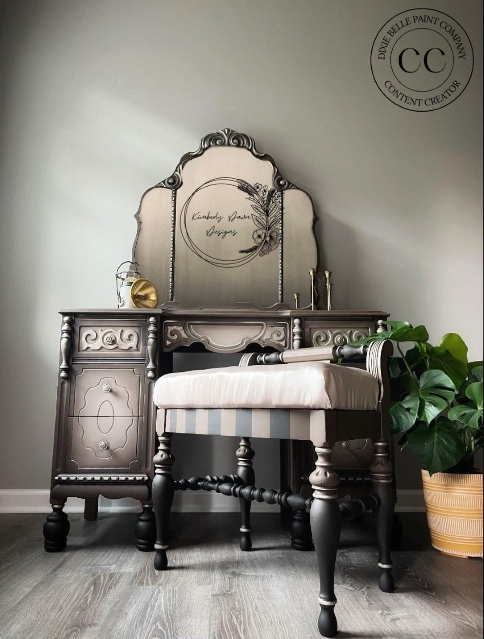 Dixie Belle Paint Chocolate Chalk Mineral Paint is the perfect paint for any DIY project!
Vanity, stool and a mirror all painted in Chocolate Chalk Mineral Paint with a potted planted besides piece.
