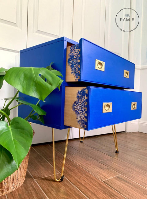 Dixie Belle Paint Cobalt Blue Chalk Mineral Paint is the perfect paint for any DIY project!
There is a medium sized dresser with two drawers. The table is painted with Cobalt Blue CMP.  The drawers have stencil done in Cobalt blue CMP that can be seen when you pull out the drawers.  The legs and pulls for the drawers are metal.