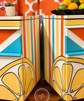 Dixie Belle Paint Daisy Chalk Mineral Paint is the perfect paint for any DIY project! Retro styled bedside tables with red, blue , white and daisy. There are also half a lemon on the front of each side table.