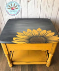 Dixie Belle Paint Daisy Chalk Mineral Paint is the perfect paint for any DIY project! An end table that is painted in daisy for the base with a black top and a sunflower transfer on top.