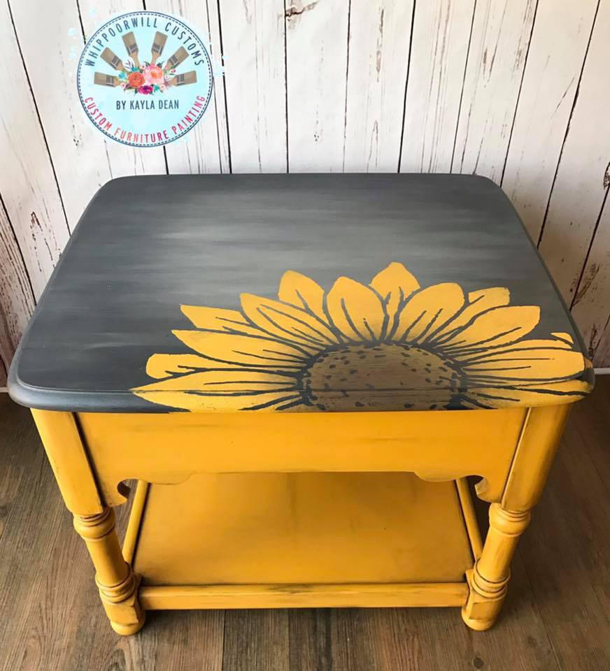 Dixie Belle Paint Daisy Chalk Mineral Paint is the perfect paint for any DIY project! An end table that is painted in daisy for the base with a black top and a sunflower transfer on top.