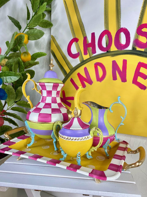 Dixie Belle Paint Daisy Chalk Mineral Paint  is the perfect paint for any DIY project! A metal tea set that is painted in daisy and an array of other colors such as pink and blue.