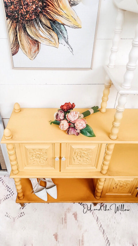 Dixie Belle Paint Daisy Chalk Mineral Paint is the perfect paint for any DIY project! An entertainment center that is painted in daisy and is staged with flowers and a pair of heels.
