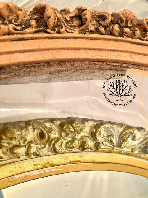 Dixie Belle Paint Dixie Dirt-4oz. 
Close up on the woodwork of two mirrors one salmon colored and the other gold using Dixie dirt in the crevasis to give a vintage feel.