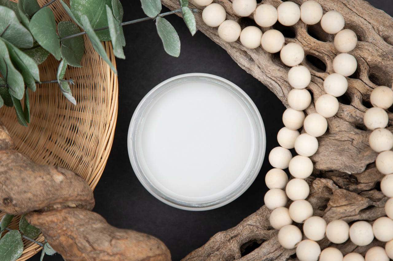 Dixie Belle Paint Driftwood Chalk Mineral Paint is the perfect paint for any DIY project! Open jar of Driftwood Chalk Mineral Paint staged with driftwood, greenery, and wooden beads.