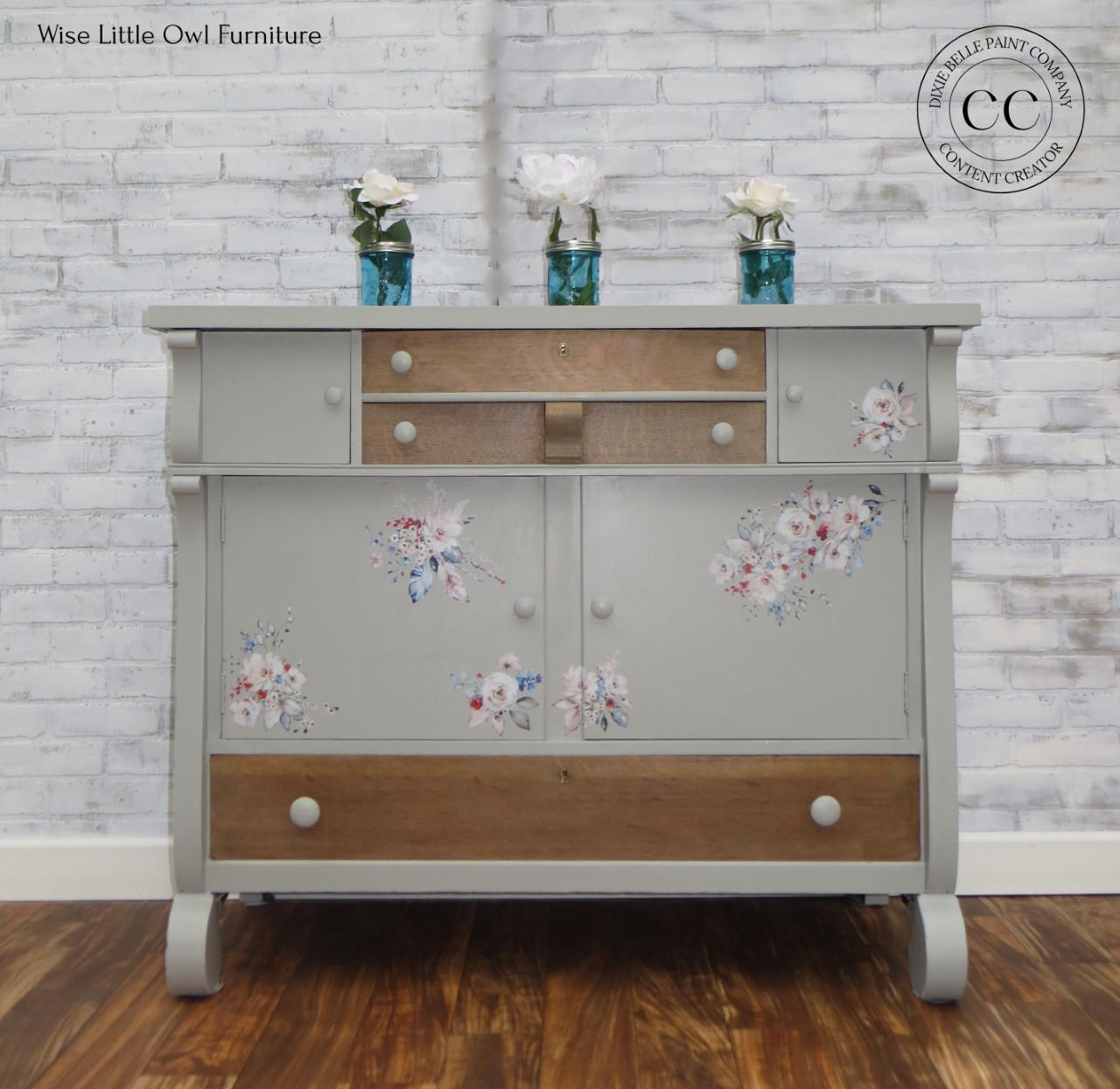 Dixie Belle Paint Driftwood Chalk Mineral Paint is the perfect paint for any DIY project!
Gray chalk painted furniture with wood accents. Mason jar vases on top with white flowers. Bohemian Wedding rub on furniture transfer added on the piece.