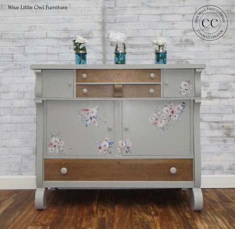 Dixie Belle Paint Driftwood Chalk Mineral Paint is the perfect paint for any DIY project!
Gray chalk painted furniture with wood accents. Mason jar vases on top with white flowers. Bohemian Wedding rub on furniture transfer added on the piece.