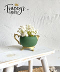 Green chalk painted pitcher with gold legs, handle and spout. Staged on a white painted distressed stool.
