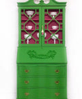 Dixie Belle Paint Evergreen Chalk Mineral Paint is the perfect paint for any DIY project! Green armoire makeover with gold handles containing white china. The inside is painted in a bright pink.