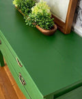 Dixie Belle Paint Evergreen Chalk Mineral Paint is the perfect paint for any DIY project! Green painted furniture makeover with bronze handles. Wooden "boat" containing faux succulents placed on top.