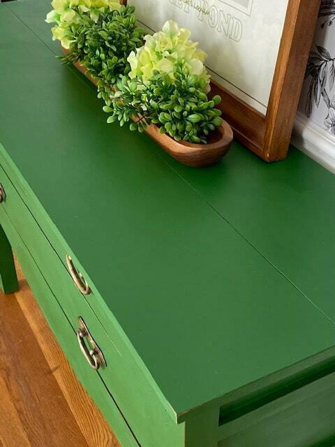 Dixie Belle Paint Evergreen Chalk Mineral Paint is the perfect paint for any DIY project! Green painted furniture makeover with bronze handles. Wooden "boat" containing faux succulents placed on top.