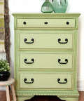 Dixie Belle Paint Farmhouse Green Chalk Mineral Paint is the perfect paint for any DIY project!
Chest of drawers painted in Farmhouse Green Chalk Mineral Paint with black hardware. Staged with 2 clear green glass vase with branches and flowers on top of the piece.