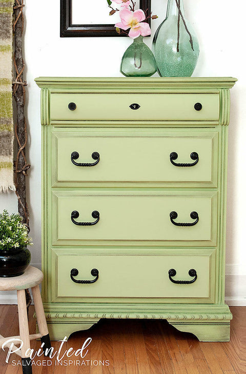 Dixie Belle Paint Farmhouse Green Chalk Mineral Paint is the perfect paint for any DIY project!
Chest of drawers painted in Farmhouse Green Chalk Mineral Paint with black hardware. Staged with 2 clear green glass vase with branches and flowers on top of the piece.