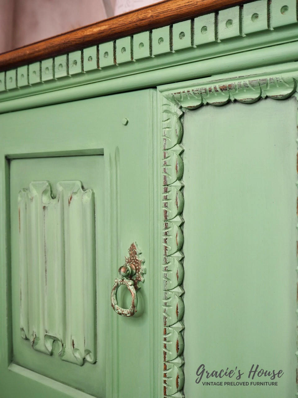 Dixie Belle Paint Farmhouse Green Chalk Mineral Paint is the perfect paint for any DIY project!
Upclose image of a Credenza door painted in Farmhouse Green Chalk Mineral Paint with distressed accents.