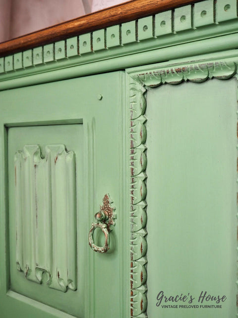 Dixie Belle Paint Farmhouse Green Chalk Mineral Paint is the perfect paint for any DIY project!
Upclose image of a Credenza door painted in Farmhouse Green Chalk Mineral Paint with distressed accents.