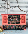 Dixie Belle Paint Flamingo Chalk Mineral Paint is the perfect paint for any DIY project!
Vintage jewelry box painted in Flamingo Chalk Mineral Paint with the drawers decoupage in Peony Pattern - Rice Paper. Staged on a white panel background, a branch is seen above the piece.