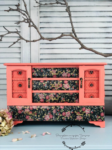 Dixie Belle Paint Flamingo Chalk Mineral Paint is the perfect paint for any DIY project!
Vintage jewelry box painted in Flamingo Chalk Mineral Paint with the drawers decoupage in Peony Pattern - Rice Paper. Staged on a white panel background, a branch is seen above the piece.