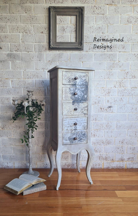 Dixie Belle Paint French Linen Chalk Mineral Paint - a tall jewelry box chalk painted with French Linen and then the Vintage Post transfer applied to the front. French Linen is a light taupe. With a warm and weathered mix of brown and gray, this gentle color  reflects light.

Use French Linen to create a polished and peaceful ambiance in any room of your home.