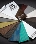Dixie Belle Paint Gel Stain Fan Deck. Displays all the colors of both lines of Gel stains, Deck is fanned out with cards that read " Gel Stain water based - oiled based Dixie Belle Paint Company" " VOODOO GEL STAIN water based gel stain" " No Pain Gel Stain Oil Based stain". Hold different color cards next to the piece of furniture you'd like to give a makeover! Staged on a black background.