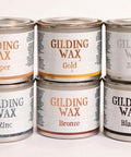 Dixie Belle Paint Gilding Wax containers in all colors stacked on top of each other.