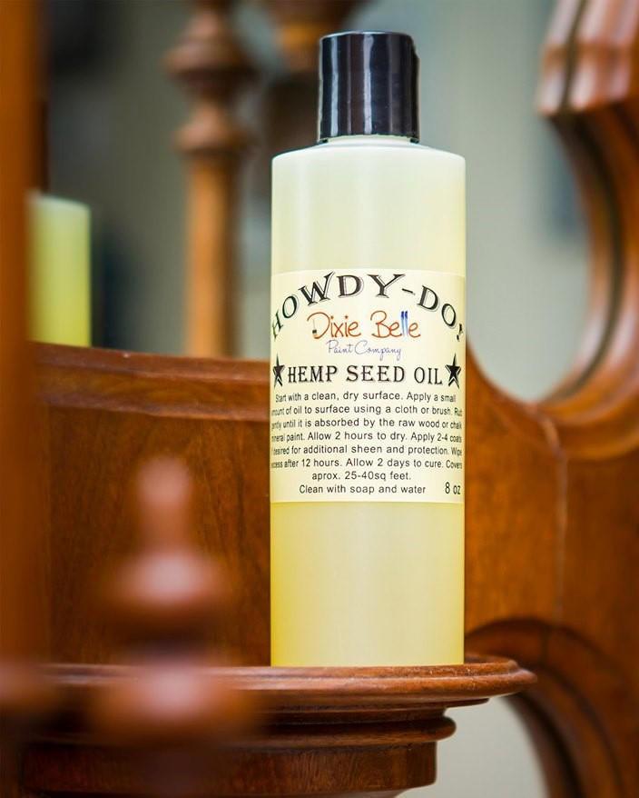 Dixie Belle Paint Howdy-Do Hemp Oil is the perfect choice for a sealant for your furniture. Bottle of Howdy-Do Hemp Oil on a wooden frame.
