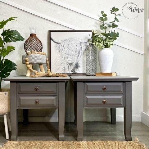 Dixie Belle Paint Hurricane Gray Chalk Mineral Paint is the perfect paint for any DIY project!
Two nightside table painted in  Hurricane Gray Chalk Mineral Paint staged with various vases, greenery, and a white picture of a long haired bull on top of the tables.