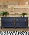 Dixie Belle Paint In the Navy Chalk Mineral Paint is the perfect paint for any DIY project!
Twin dresser set painted in In the Navy Chalk Mineral Paint along with gold hardware. Staged with gold frames on the wall hanging above the pieces, a gold houseplant pot, and a gold horse head statue on one of the dressers.