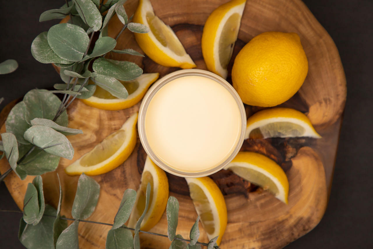 Dixie Belle Paint Lemonade Chalk Mineral Paint is the perfect paint for any DIY project!
Top view of an opened container of Lemonade Chalk Mineral Paint staged with lemon slices,a whole lemon and an eucalyptus branches on top of a round wooden board.