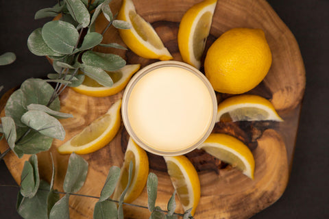 Dixie Belle Paint Lemonade Chalk Mineral Paint is the perfect paint for any DIY project!
Top view of an opened container of Lemonade Chalk Mineral Paint staged with lemon slices,a whole lemon and an eucalyptus branches on top of a round wooden board.