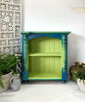 Dixie Belle Paint Limeade Chalk Mineral Paint is the perfect paint for any DIY project!
A blue and green blended bookcase with Limeade Chalk Mineral Paint on the inside of the case as well as Pearlescent Glaze is use over the blended ares on the woodwork . Staged with ceramic pots with greenery around the piece in a white room.