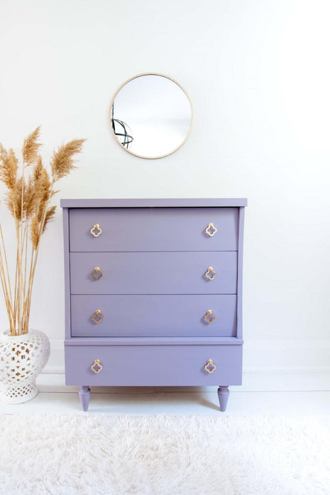 Dixie Belle Paint Lucky Lavender Chalk Mineral Paint is the perfect paint for any DIY project!
Beautiful white minimalistic stage with a dresser painted in Lucky Lavender Chalk Mineral Paint and gold hardware