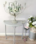 Dixie Belle Paint Manatee Gray Chalk Mineral Paint is the perfect paint for any DIY project! Light Gray Chalk Painted Side Table with Floral Rub on Transfers. Staged with a candle stick holder and milk can with flowers.