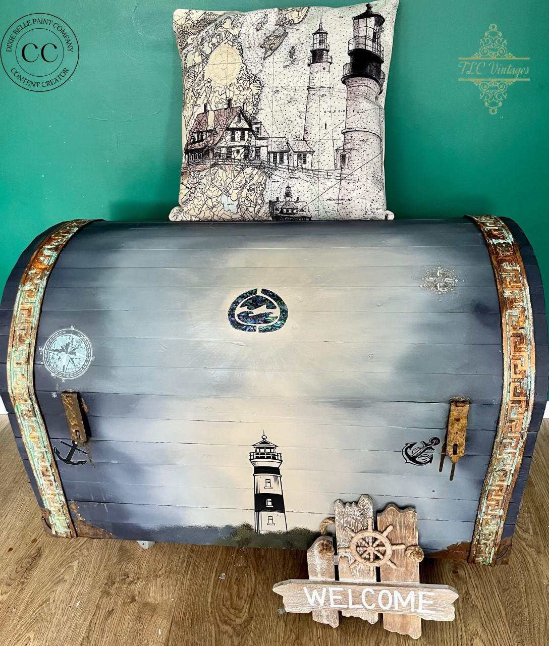 Dixie Belle Paint Manatee Gray Chalk Mineral Paint is the perfect paint for any DIY project! Blue Gray Chalk Painted Trunk with Nautical Rub on Transfers. Staged with a nautical lighthouse pillow and a welcome sign.