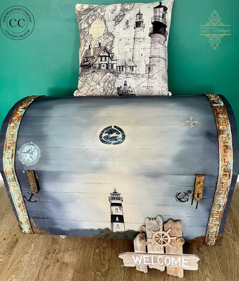 Dixie Belle Paint Manatee Gray Chalk Mineral Paint is the perfect paint for any DIY project! Blue Gray Chalk Painted Trunk with Nautical Rub on Transfers. Staged with a nautical lighthouse pillow and a welcome sign.