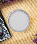 Dixie Belle Paint Mason Dixon Gray Chalk Mineral Paint is the perfect paint for any DIY project! Can of Mason Dixon Gray Chalk paint Sitting on a scripted background with purple flowers.
