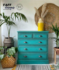 Dixie Belle Paint Mermaid Tail Chalk Mineral Paint is the perfect paint for any DIY project! Teal Chalk Painted Dresser staged with some potted palm trees, a yellow vase with wheat in it and a boho style rug and wall hanging décor.