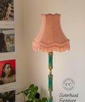 Dixie Belle Paint Mermaid Tail Chalk Mineral Paint is the perfect paint for any DIY project! Lamp Post painted in Teal Chalk Mineral paint and dusted with Gold wax with pink lamp shade. Staged next to a gallery wall and plants.