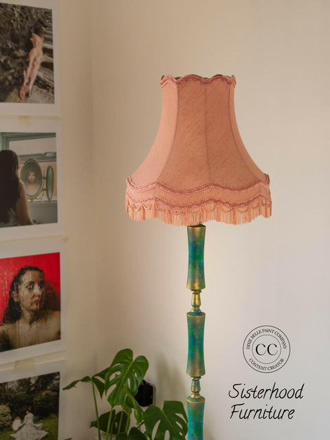 Dixie Belle Paint Mermaid Tail Chalk Mineral Paint is the perfect paint for any DIY project! Lamp Post painted in Teal Chalk Mineral paint and dusted with Gold wax with pink lamp shade. Staged next to a gallery wall and plants.